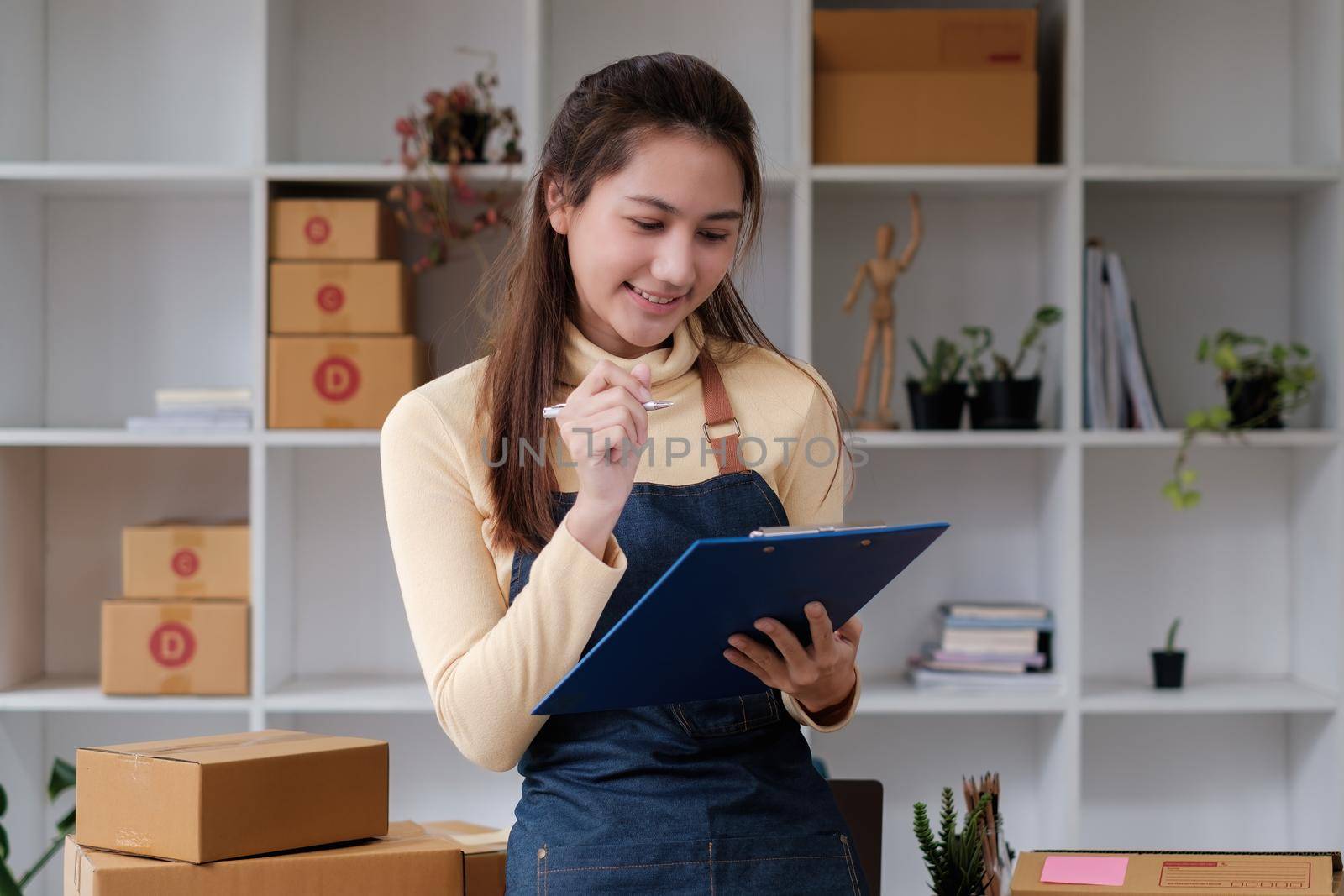 Asian small business owner working at home office. Business retail market and online sell marketing delivery, SME e-commerce concept by itchaznong