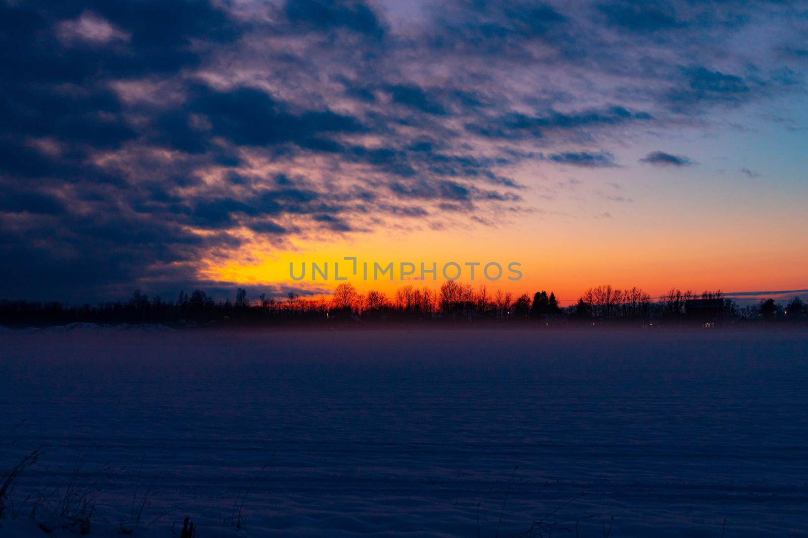 Winter sunset in the field . Winter landscape. Nature.