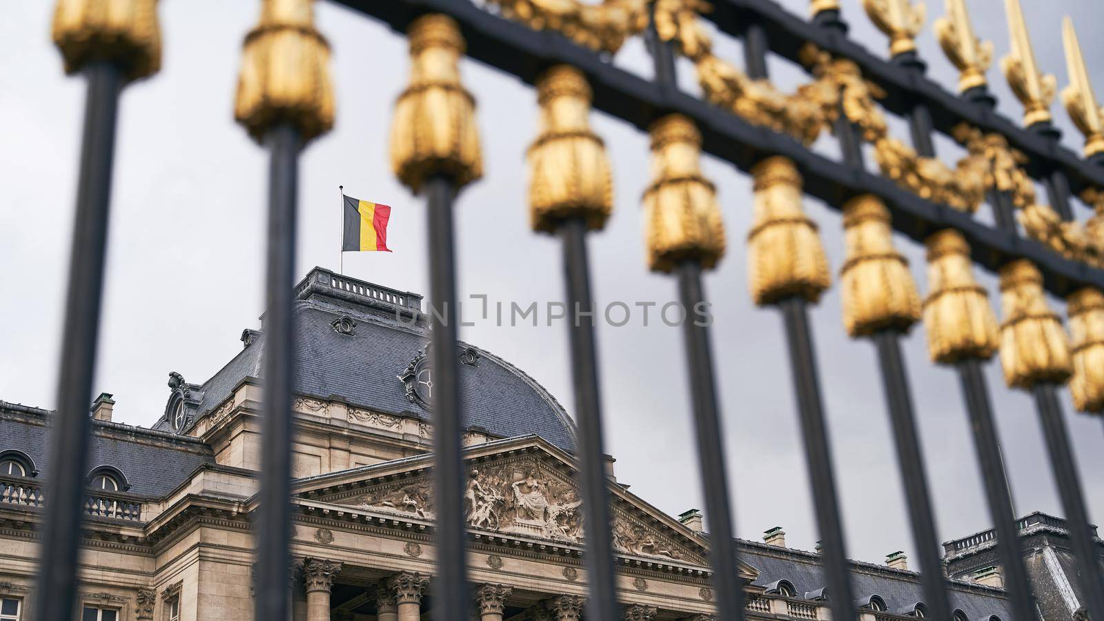 The Royal Palace in Brussels, Belgium. View through the metal fence with golden details