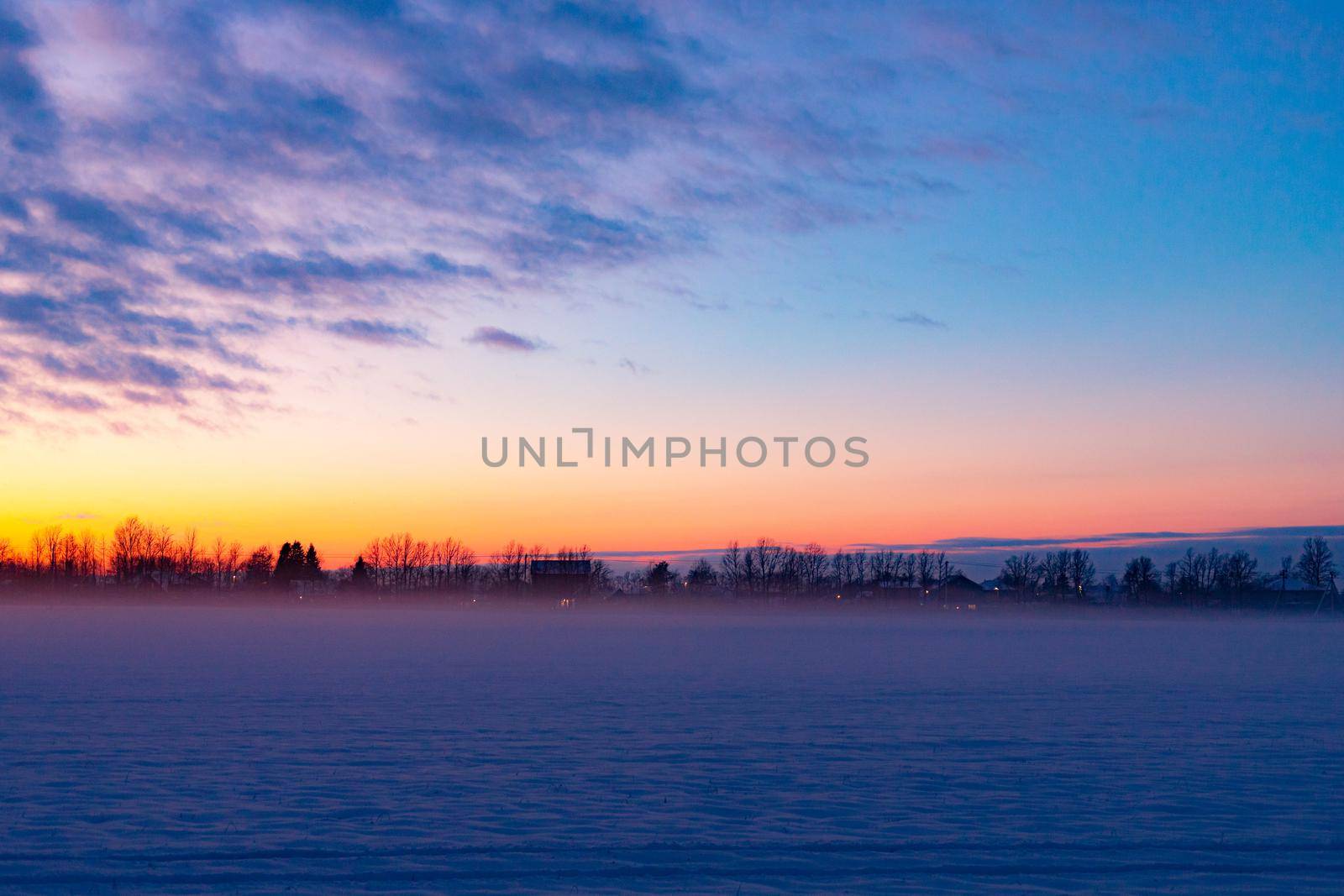 Winter sunset in the field . Winter landscape. Nature.