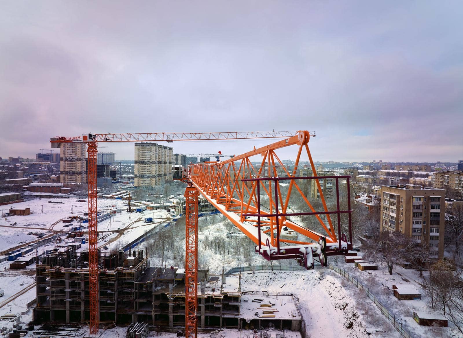 Construction Crane from Above. tower crane on the construction site aerial view. Aerial View Of construction site with crane. Construction workers are building. Top view.