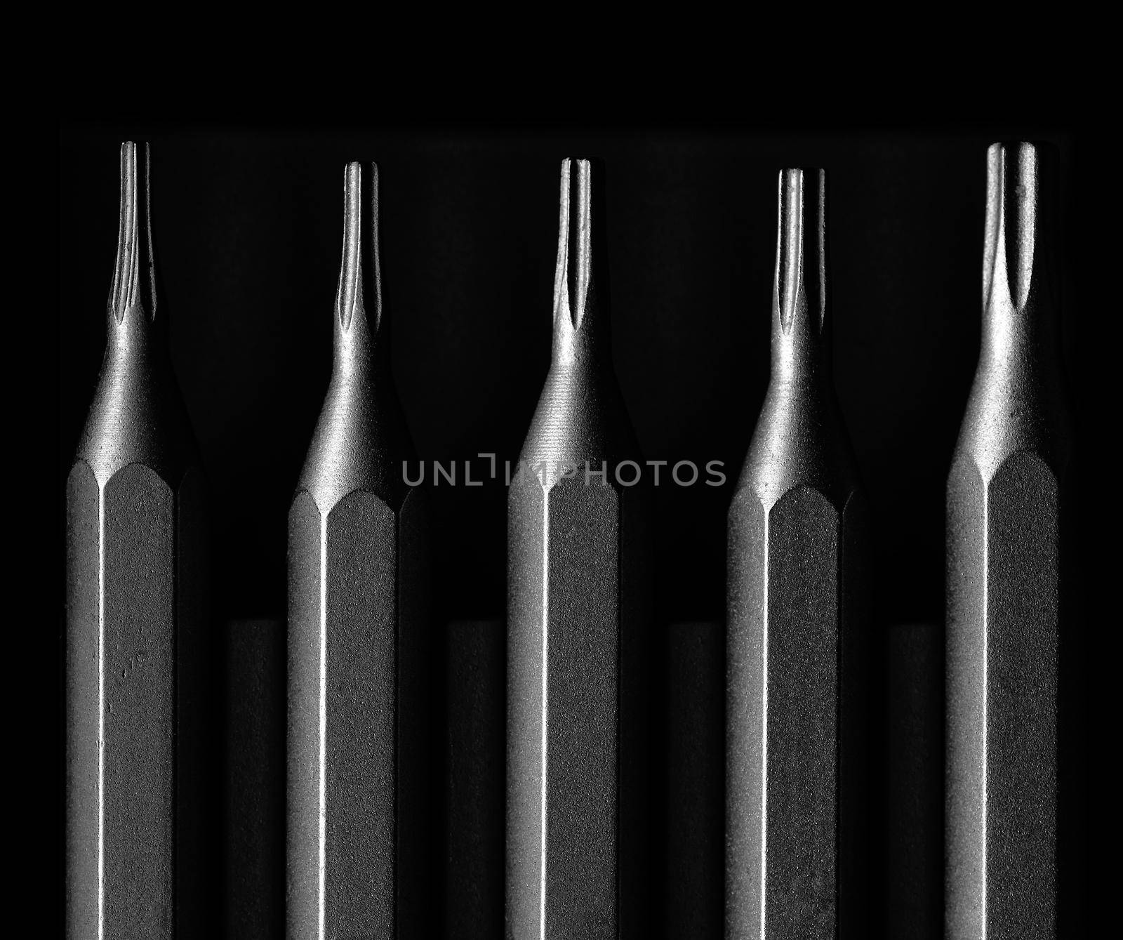 Screwdriver tips different shapes and sizes close up. Manual metal mini screwdriver and set of the interchangeable bits. Precision Screwdriver Kit. Steel Precision Magnetic Bits by EvgeniyQW