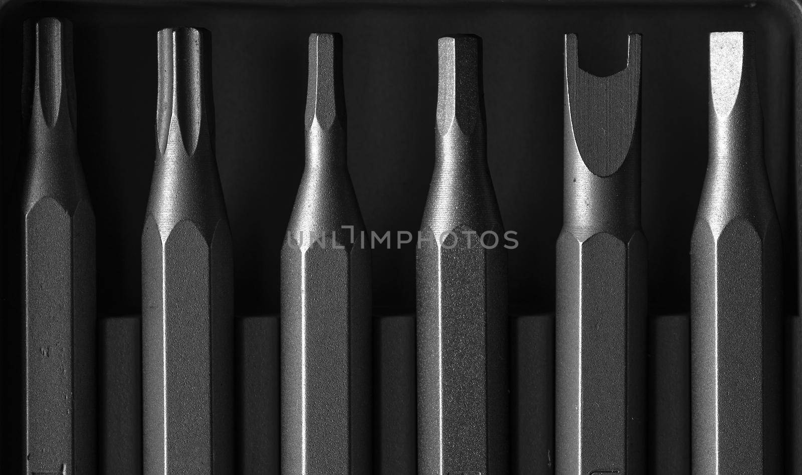Screwdriver tips different shapes and sizes close up. Manual metal mini screwdriver and set of the interchangeable bits. Precision Screwdriver Kit. Steel Precision Magnetic Bits by EvgeniyQW