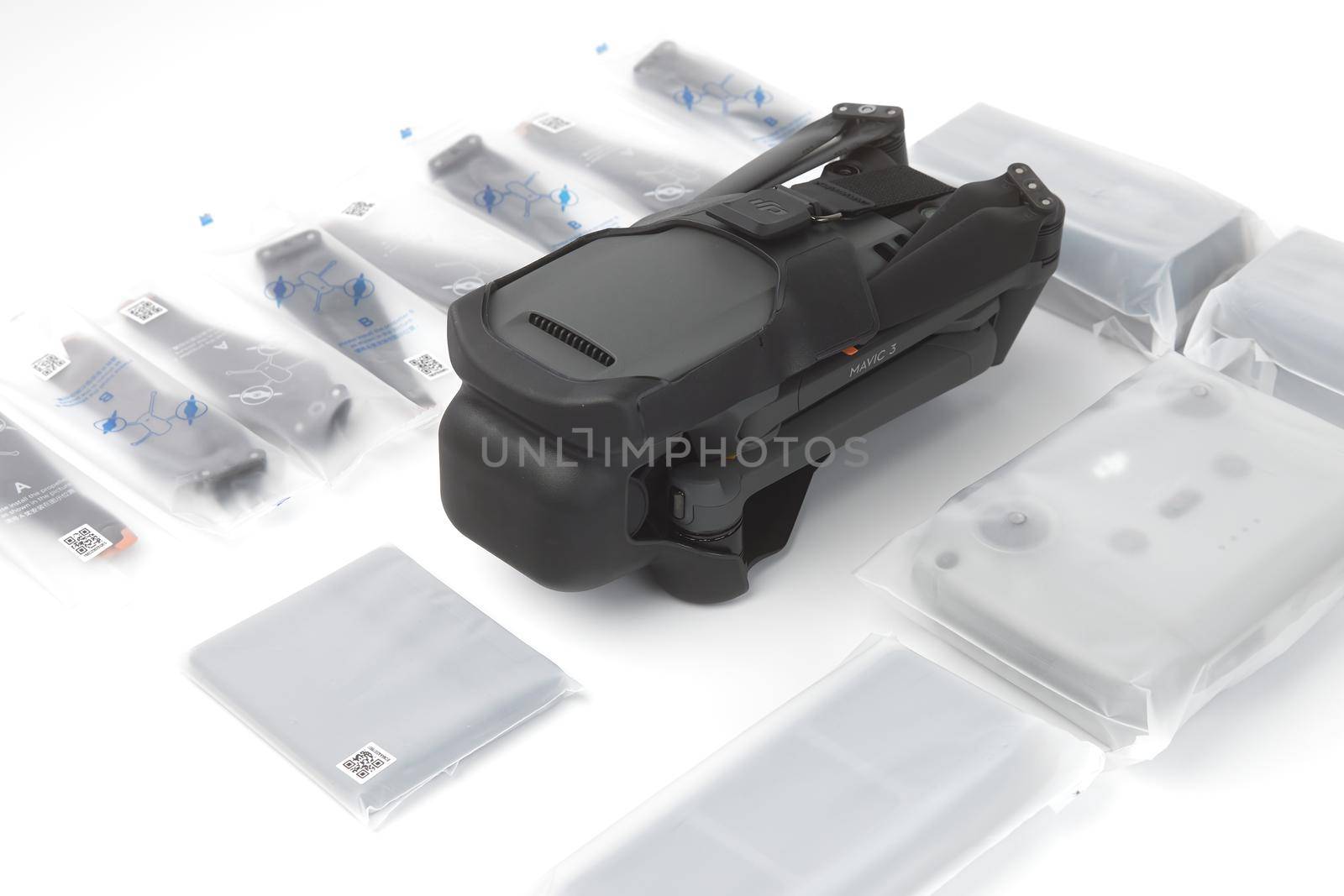 New DJI Mavic 3 drone on a white background when unpacking. Parts of the delivery set in the original packaging. DJI world leader developer and manufacturers in UAV. 17.12.2021, Rostov region, Russia.