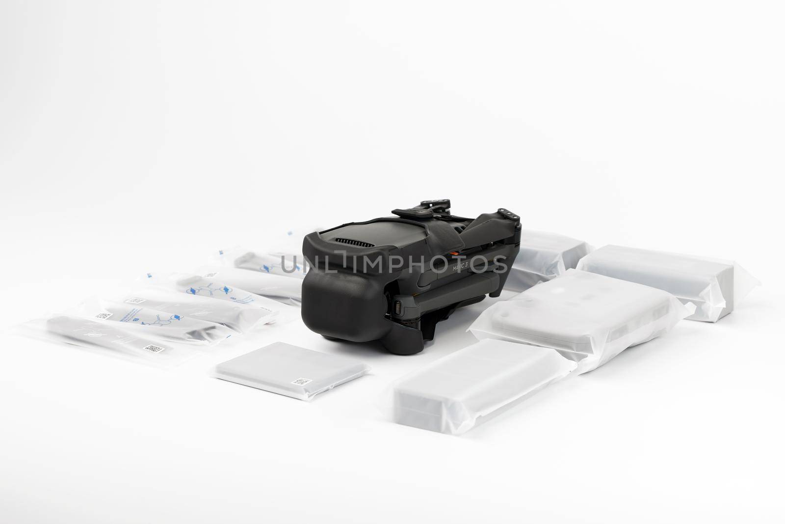 New DJI Mavic 3 drone on a white background when unpacking. Parts of the delivery set in the original packaging. DJI world leader developer and manufacturers in UAV. 17.12.2021, Rostov region, Russia.