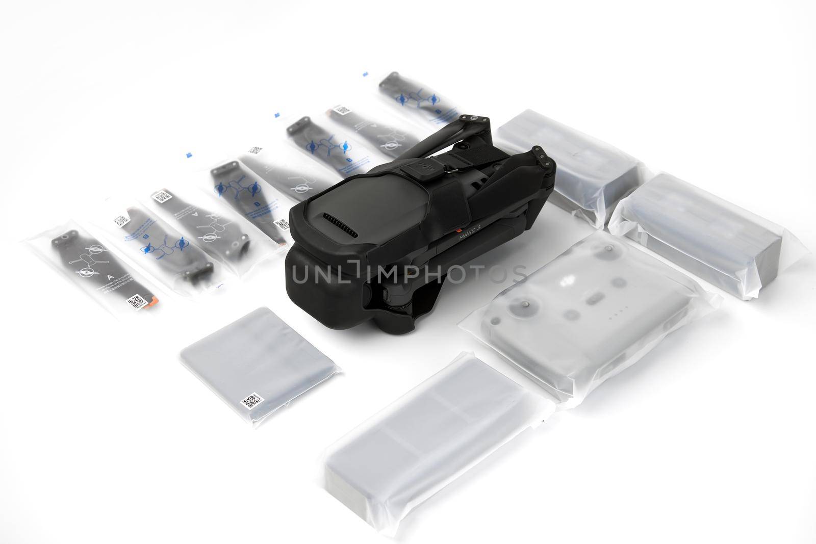 New DJI Mavic 3 drone on a white background when unpacking. Parts of the delivery set in the original packaging. DJI world leader developer and manufacturers in UAV. 17.12.2021, Rostov region, Russia.