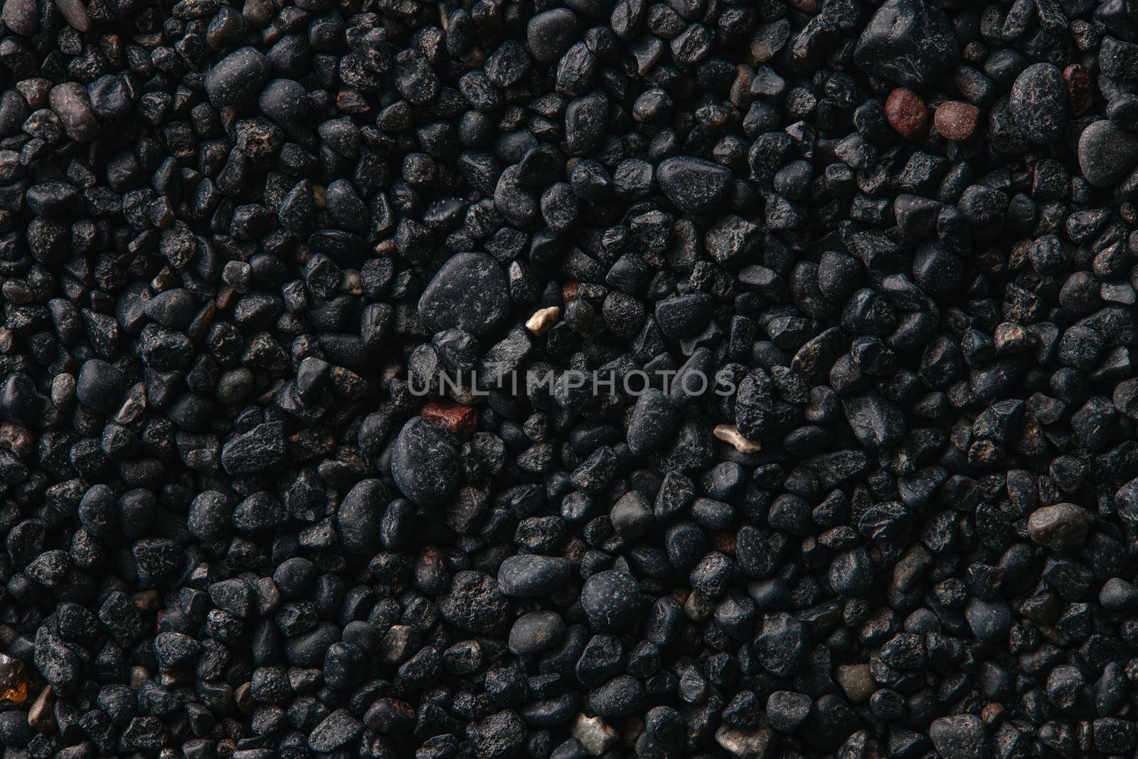 Texture of black volcanic sand for background. Black Sand beach macro photography. Close-up view of volcanic sand surface. Icelandic Black Sand macro photography. Black pebble background by EvgeniyQW