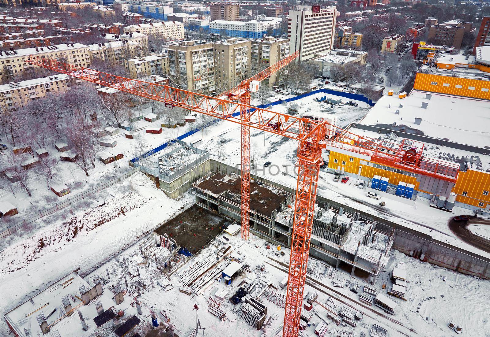 Construction Crane from Above. tower crane on the construction site aerial view. Aerial View Of construction site with crane. Construction workers are building. Top view by EvgeniyQW