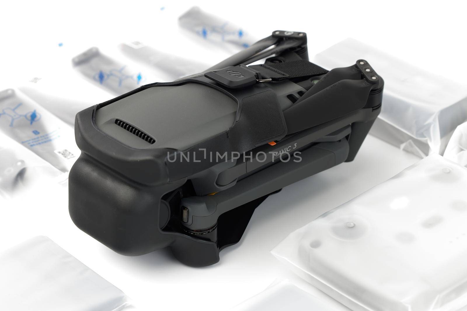 New DJI Mavic 3 drone on a white background when unpacking. Parts of the delivery set in the original packaging. DJI world leader developer and manufacturers in UAV. 17.12.2021, Rostov region, Russia.