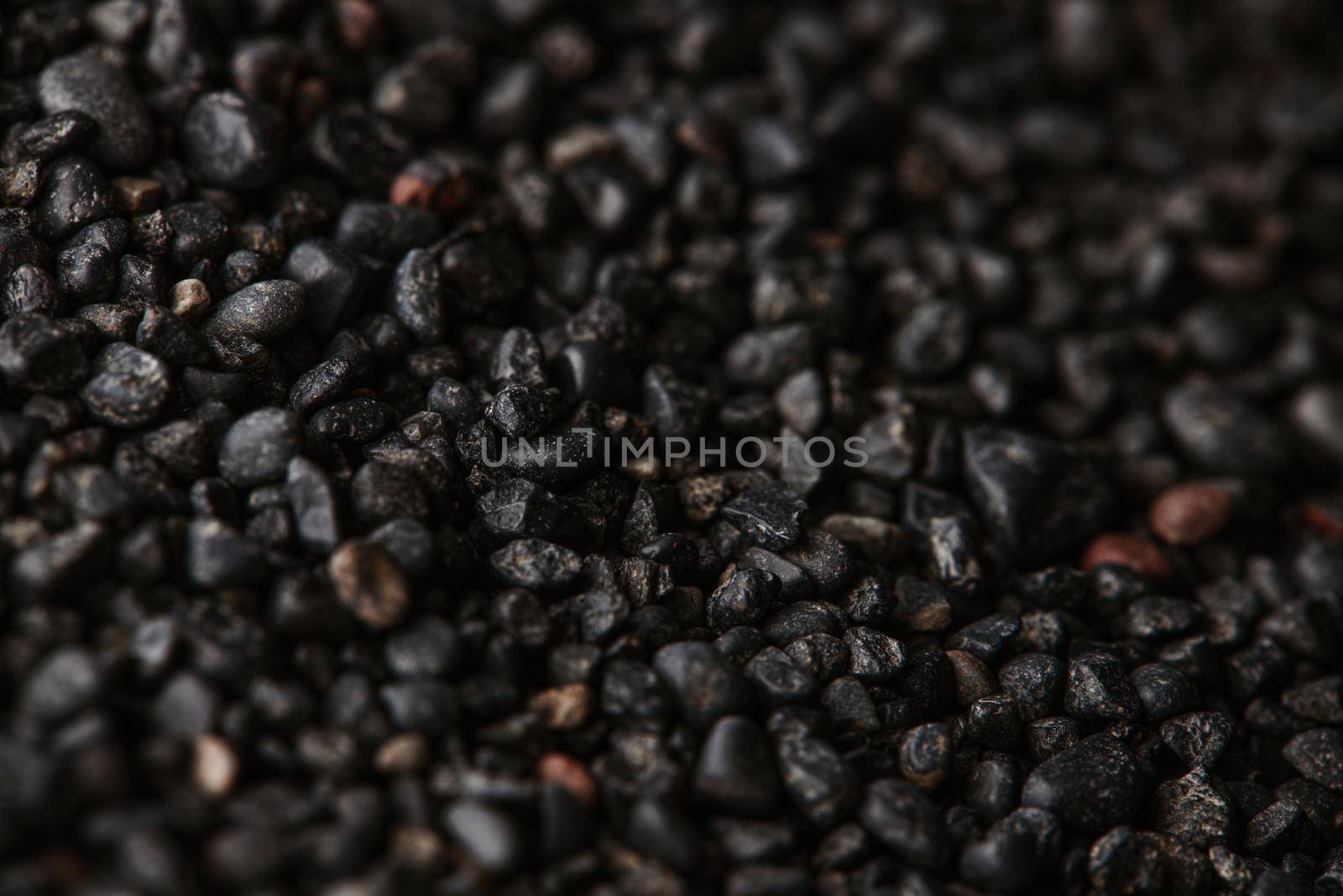 Texture of black volcanic sand for background. Black Sand beach macro photography. Close-up view of volcanic sand surface. Icelandic Black Sand macro photography. Black pebble background by EvgeniyQW