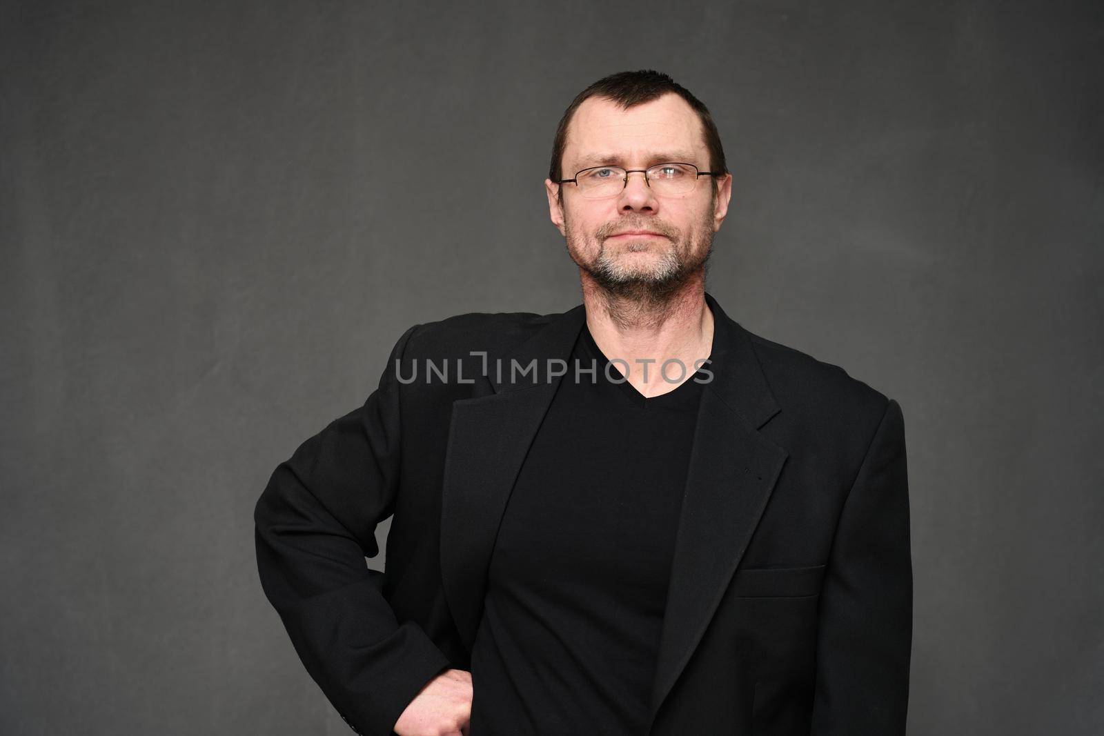 Portrait of a business man with a smile on a black background