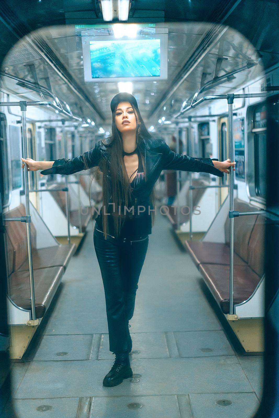 Stylish Beautiful Woman Standing inside Empty Subway Car. Sexy Caucasian Woman of 20s in Empty Underground Train. Full-length. High quality photo
