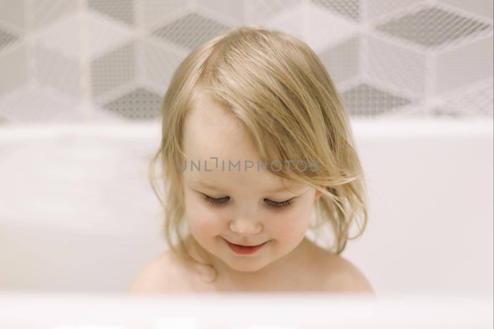 Child bathing. Little baby taking bath, closeup face portrait of smiling girl, health care and kids hygiene by paralisart
