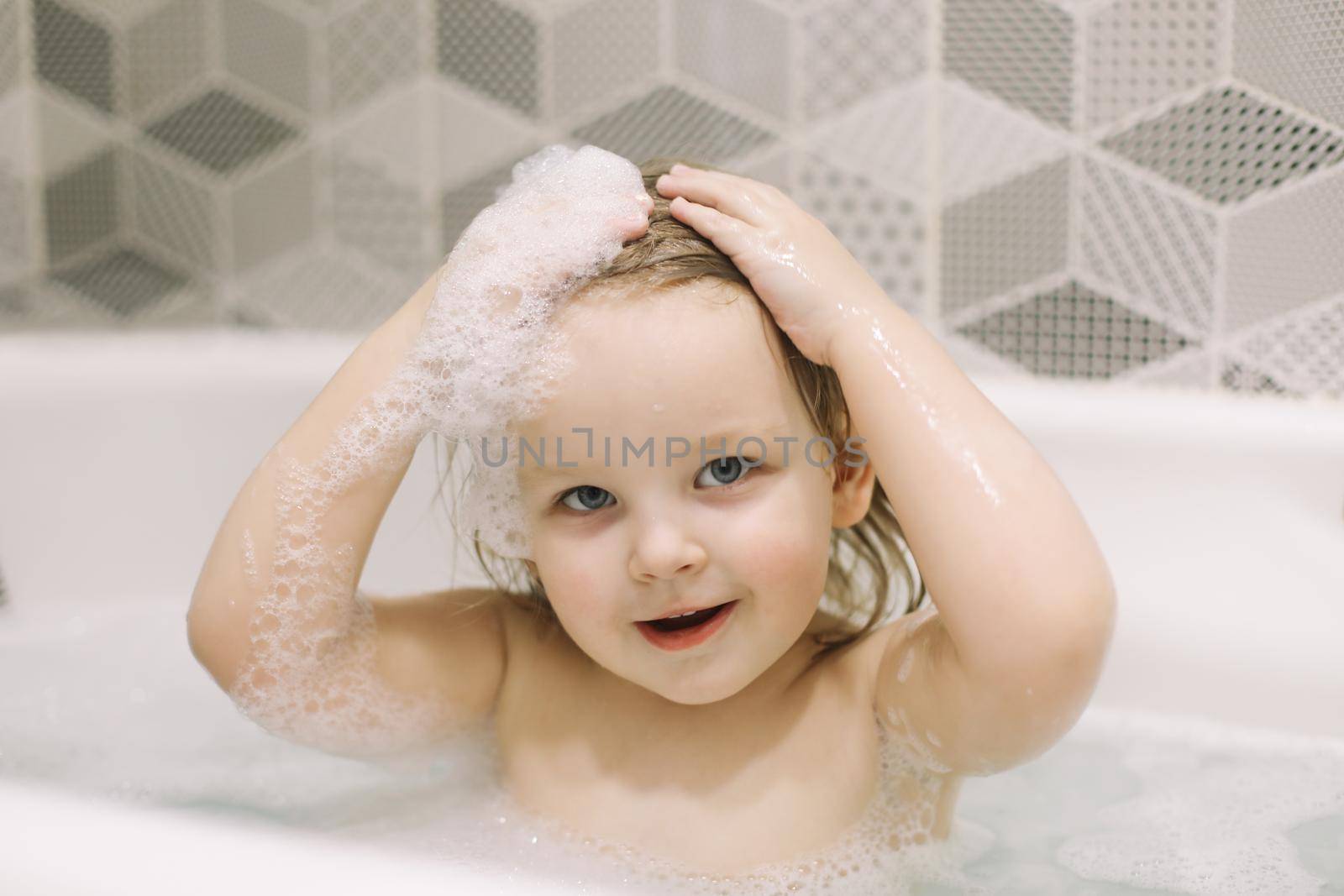 Child bathing. Little baby taking bath, closeup face portrait of smiling girl, health care and kids hygiene by paralisart
