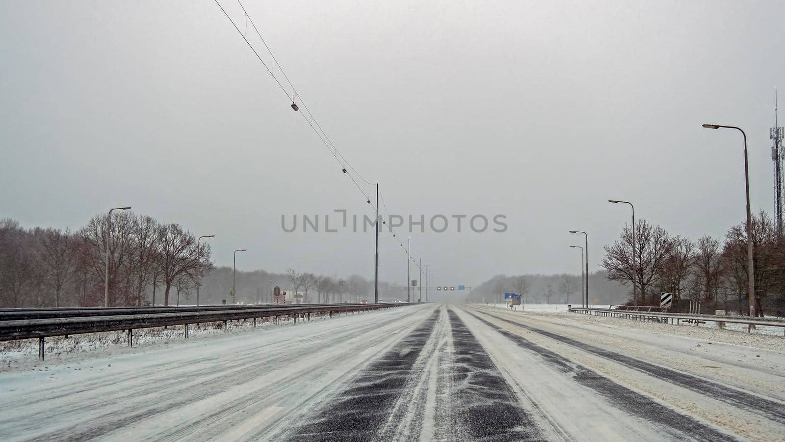 Driving in a snowstorm on the highway A1 near Amsterdam in the Netherlands in winter