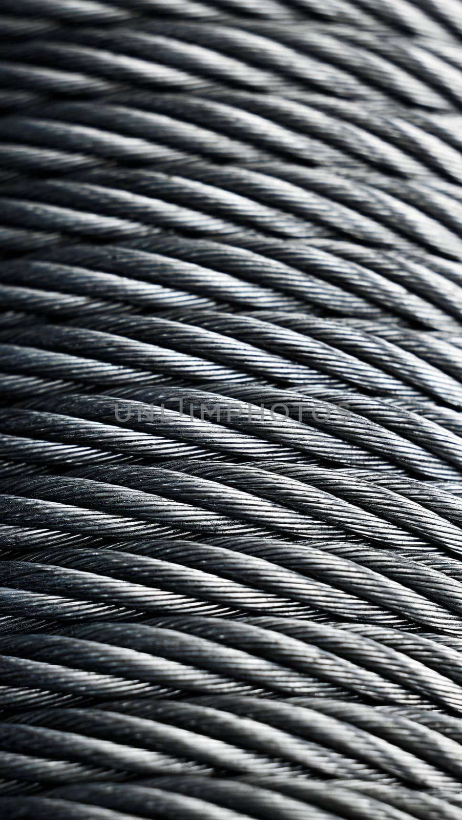 Metal cable winch. Steel rope winch close-up. Strong still background.
