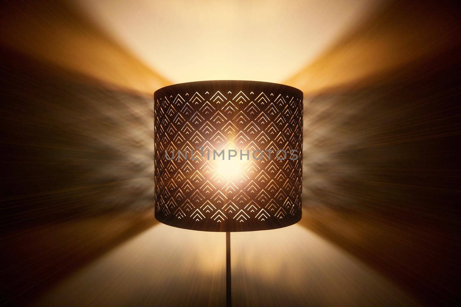 Floor lamp light. Rays of light through the holes in the lamp floor lamp. Bright shining lamp in the night.