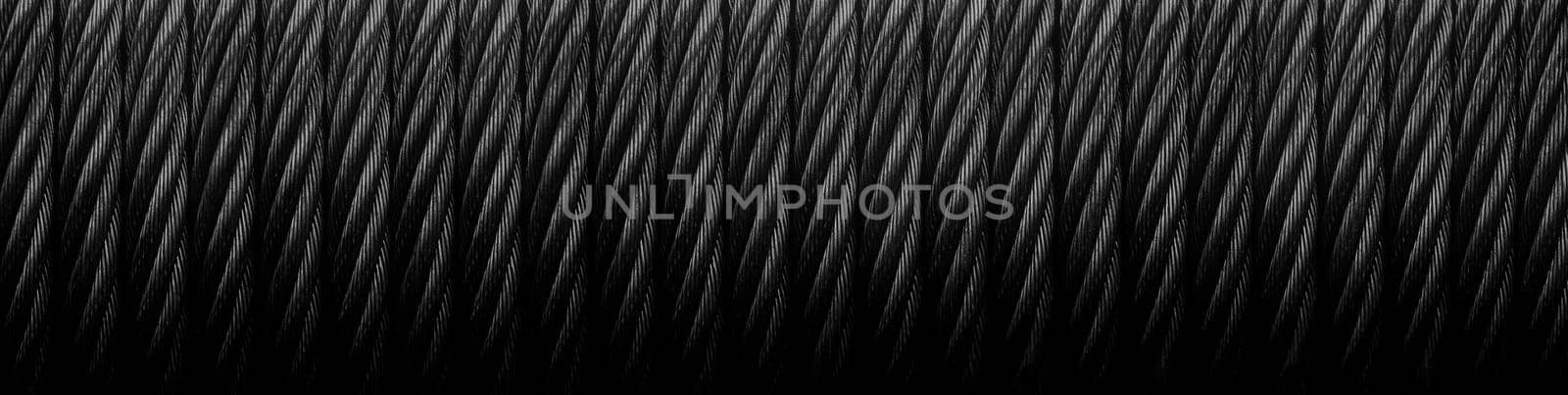 Metal cable. Metal cable winch. Black Steel rope winch close-up. Strong still Black background.