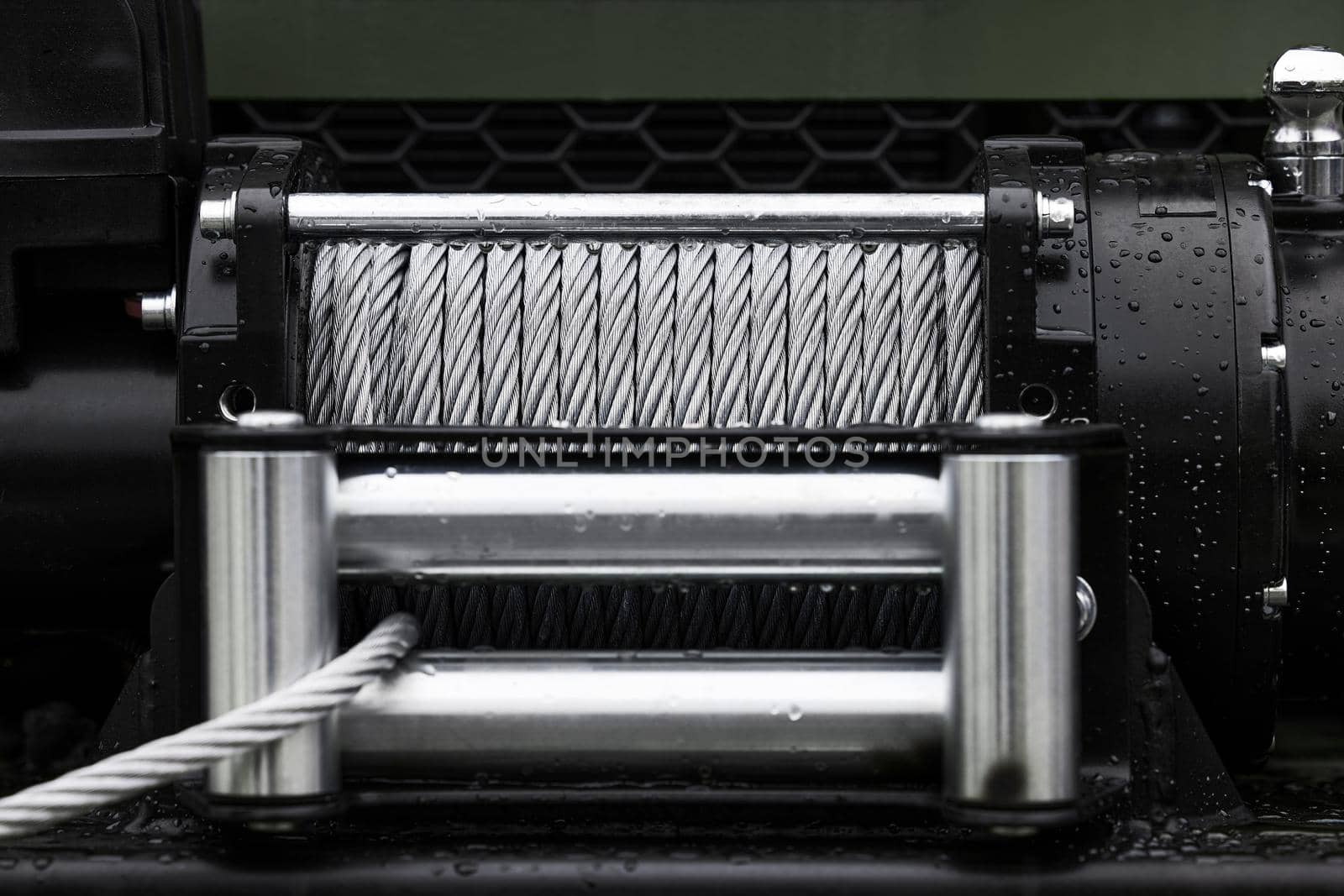 Powerful winch with steel rope. Metal cable winch. Steel rope winch close-up.