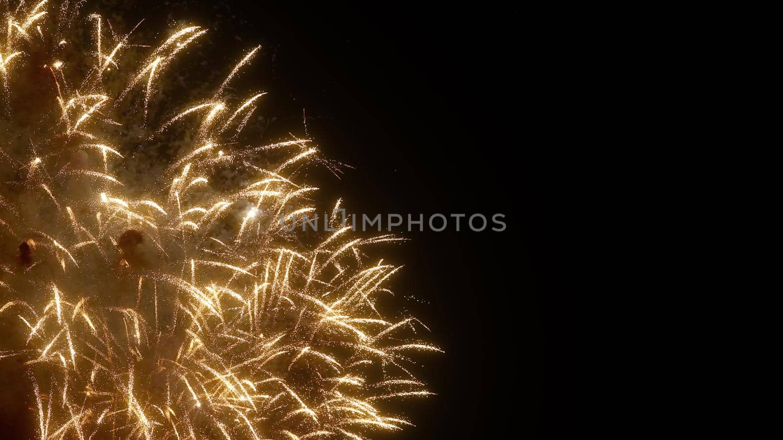 Golden fireworks of various colors over night sky, Real Fireworks on Deep Black Background Sky on Fireworks festival show before independence day on 4 of July. Beautiful fireworks show.