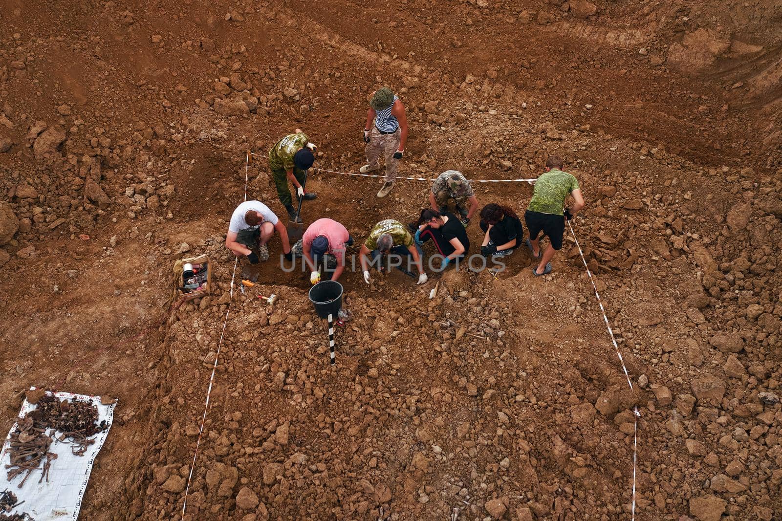 Excavations at the site of a war crime. Site of a mass shooting of people. Human remains (bones of skeleton, skulls). Human remains of victims of the Nazis. 28.08.2021, Rostov region, Russia.