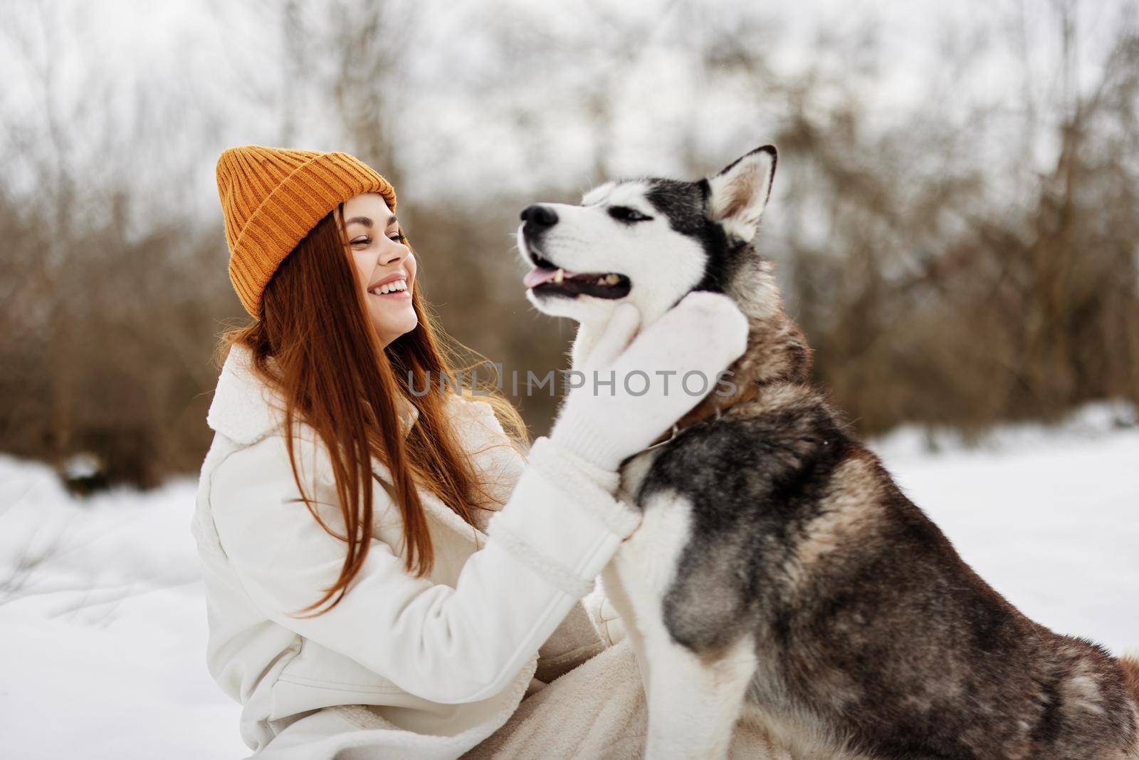 Happy young woman winter outdoors with a dog fun nature winter holidays by SHOTPRIME
