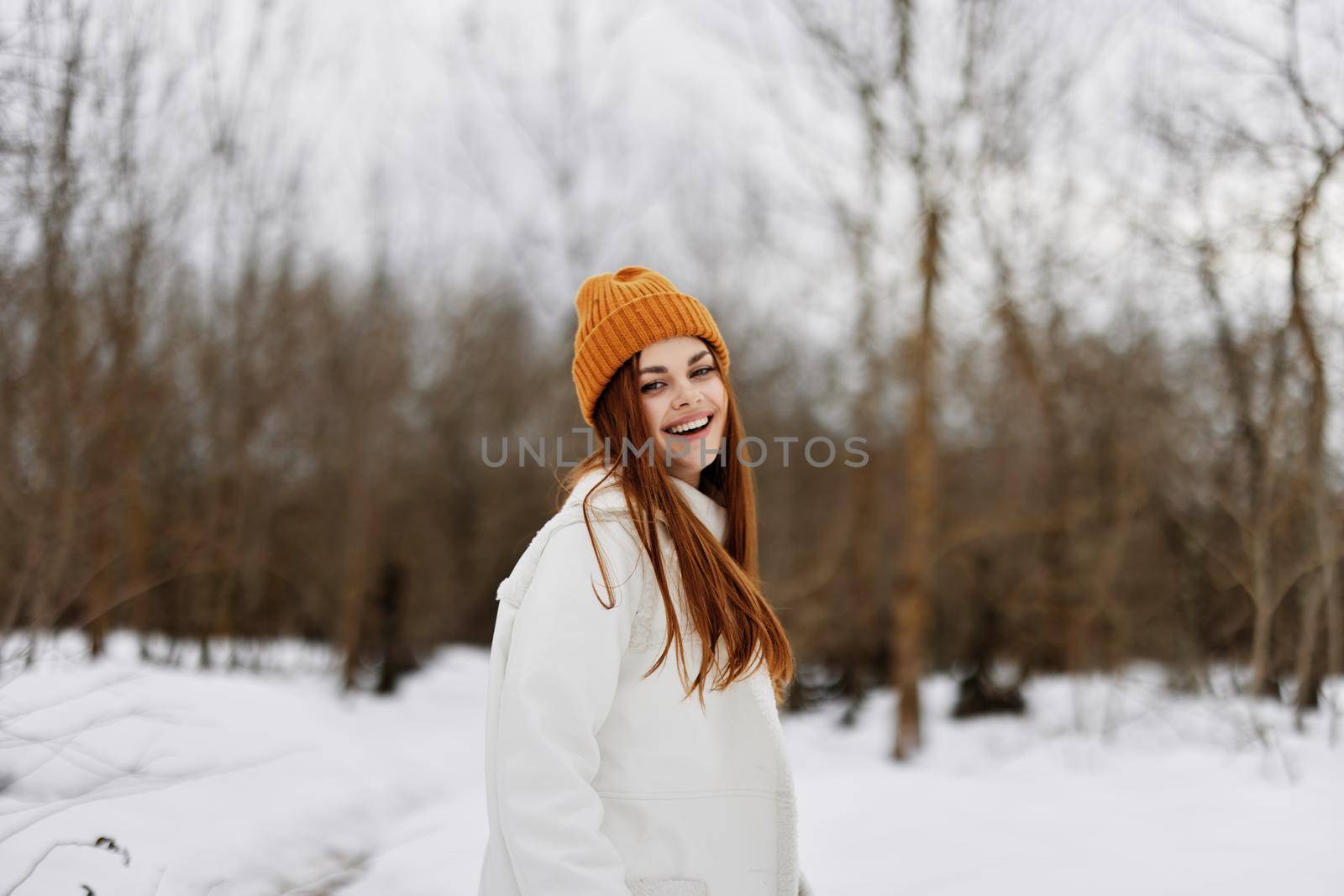 cheerful woman in winter clothes in a hat fun winter landscape winter holidays by SHOTPRIME