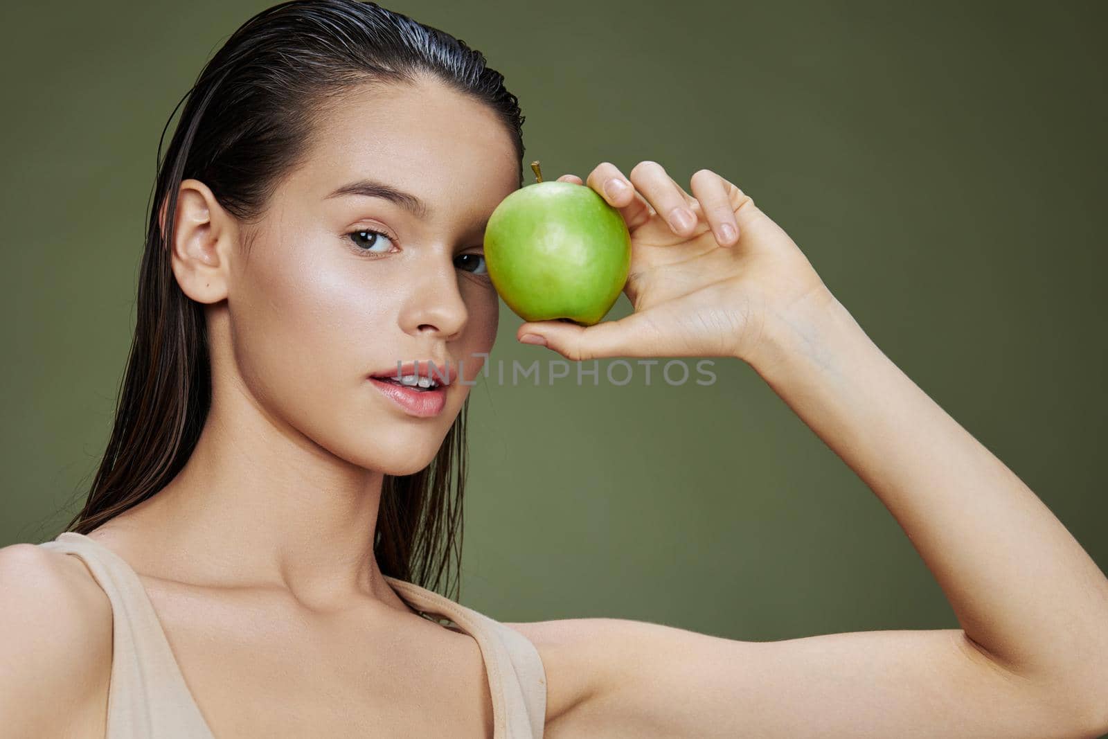 brunette happy smile green apple health Green background. High quality photo