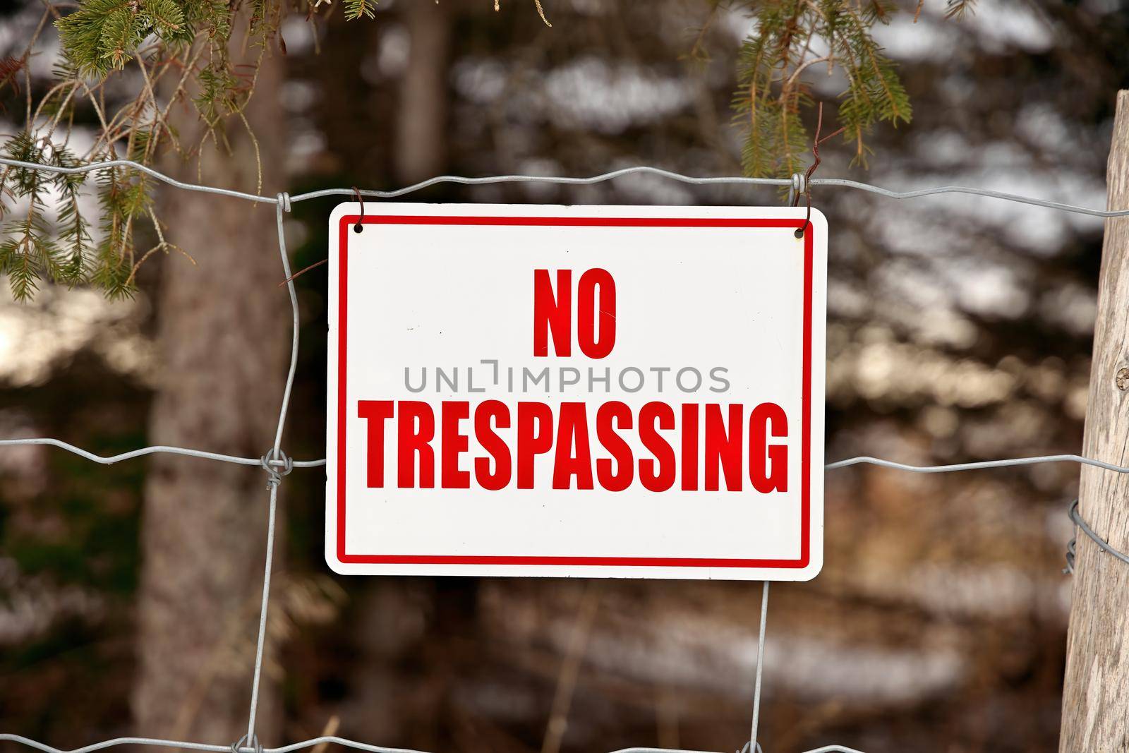 No Trespassing Sign Posted on a Wire Fence in a Rural Setting by markvandam