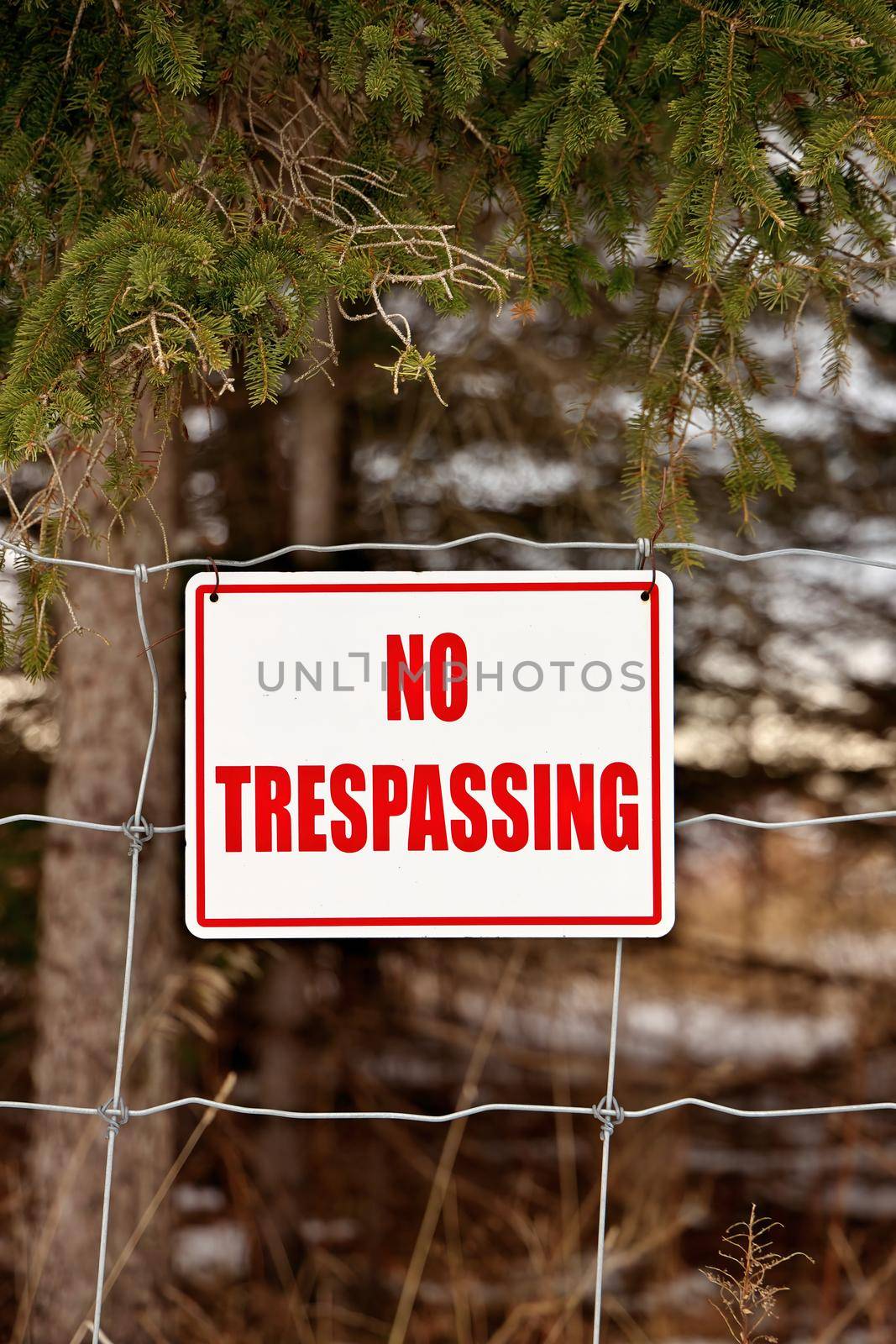 No Trespassing Sign Posted on a Wire Fence in a Rural Setting. High quality photo