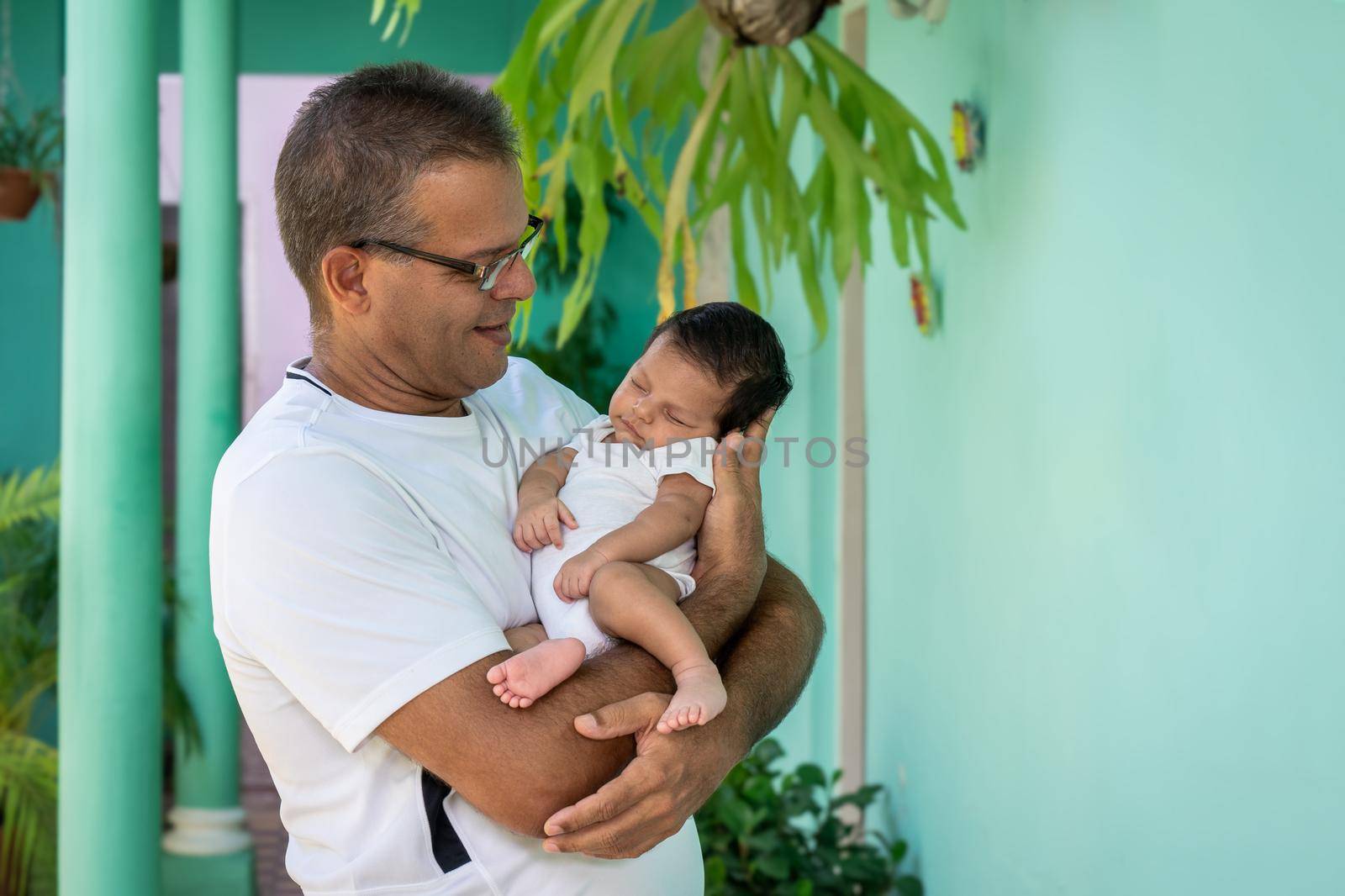 Photo of a baby in the arms of a man