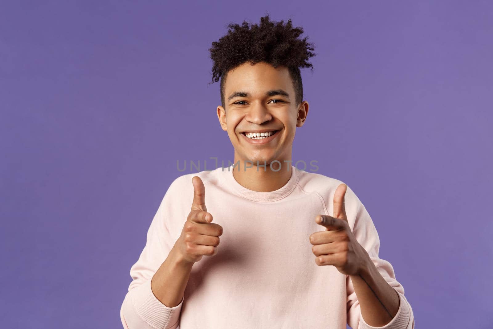 You got it. Close-up portrait of smiling cute young hispanic man saying good luck, pointing fingers at camera with pleased cute grin, encourage person apply for job, headhunter picking new candidates by Benzoix