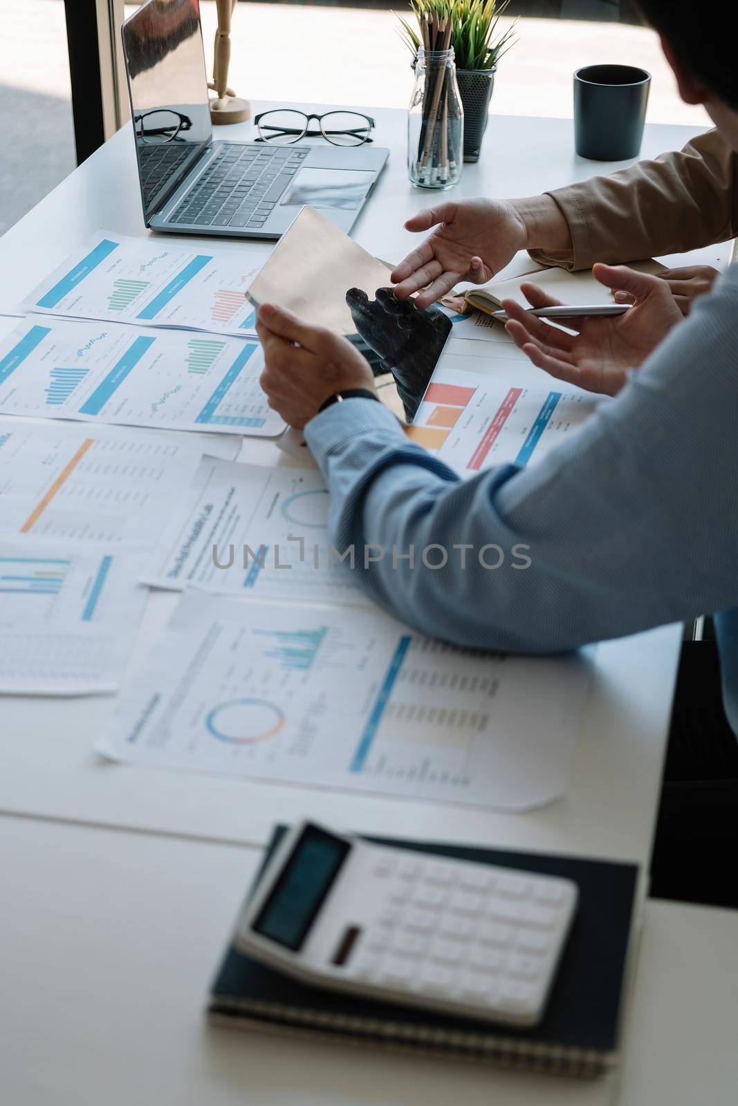 Business team present. Business man hands hold documents with financial statistic stock photo, discussion, and analysis report data the charts and graphs. Finance concept by nateemee