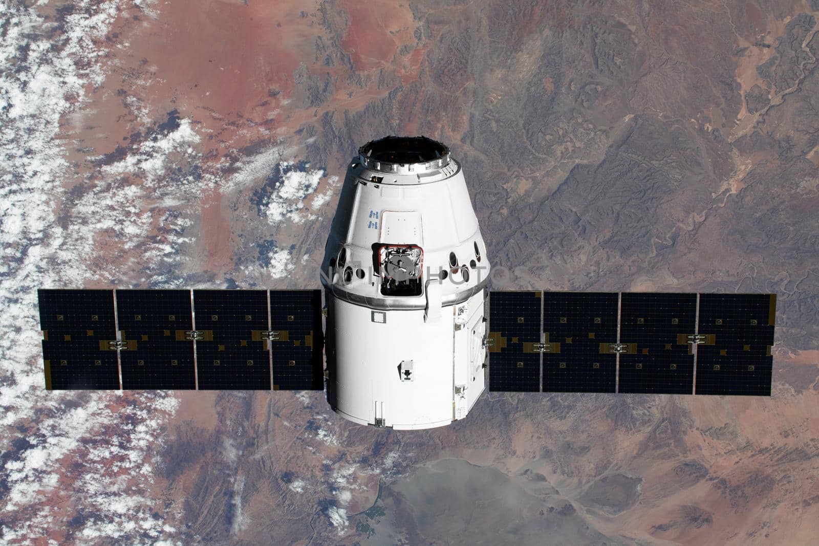 The SpaceX Dragon resupply ship is pictured approaching the International Space Station. Elements of this image furnished by NASA.