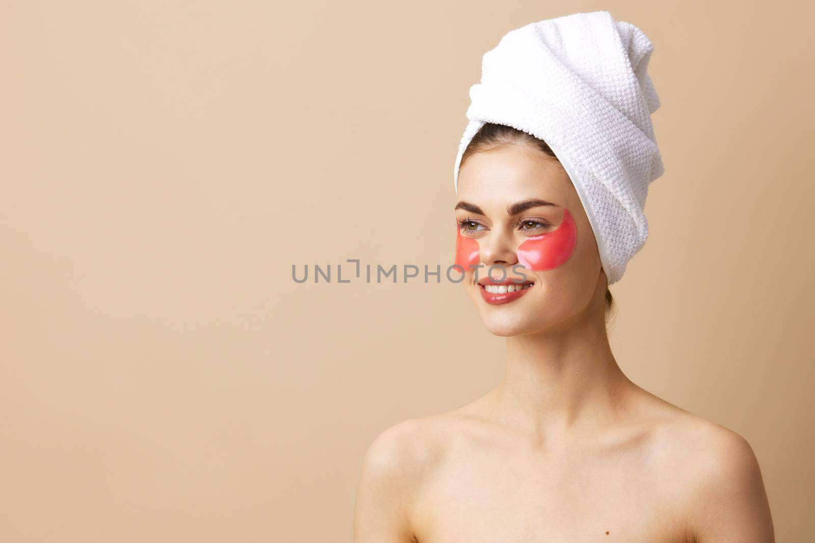 woman with a towel on his head gesturing with his hands skin care close-up Lifestyle. High quality photo