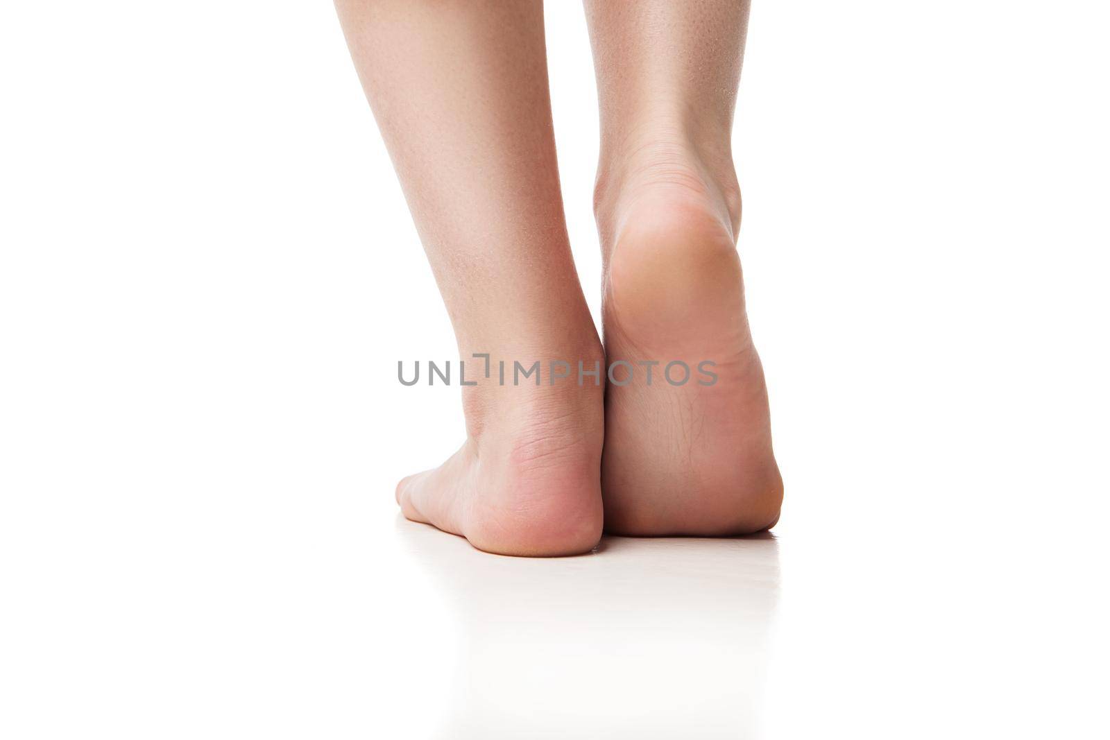 Woman foot on white background, isolated, close-up. Back view