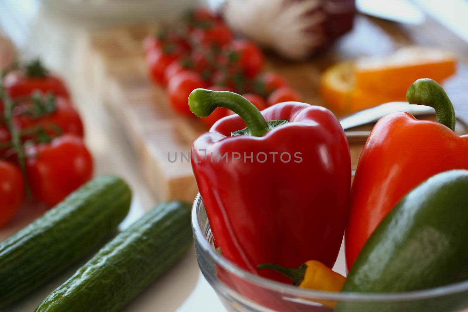 Close-up of bowl with fresh vegetables inside, ripe red pepper, cucumber, tomatoes for salad. Cooking, chef, food, kitchen, new recipe idea, taste concept