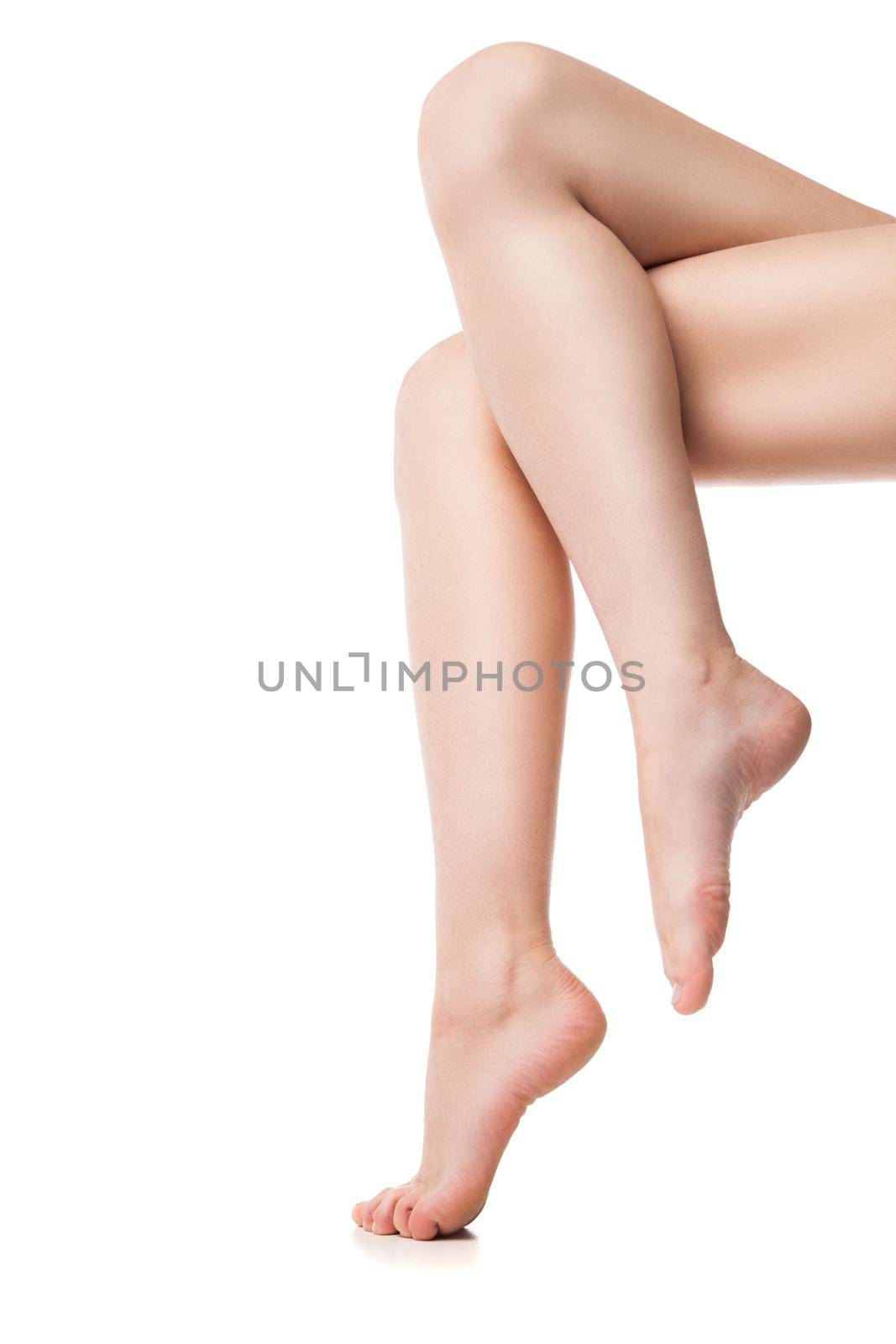 Close up of legs of young woman. Isolated on background