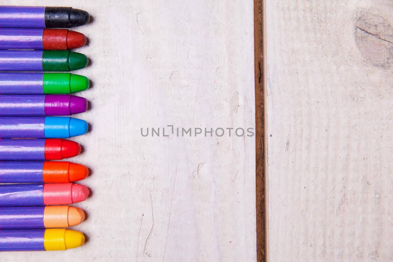 Set of wax crayons on wood table