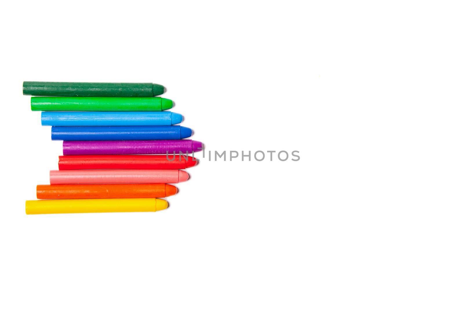 Crayons lined up in rainbow isolated on white background.