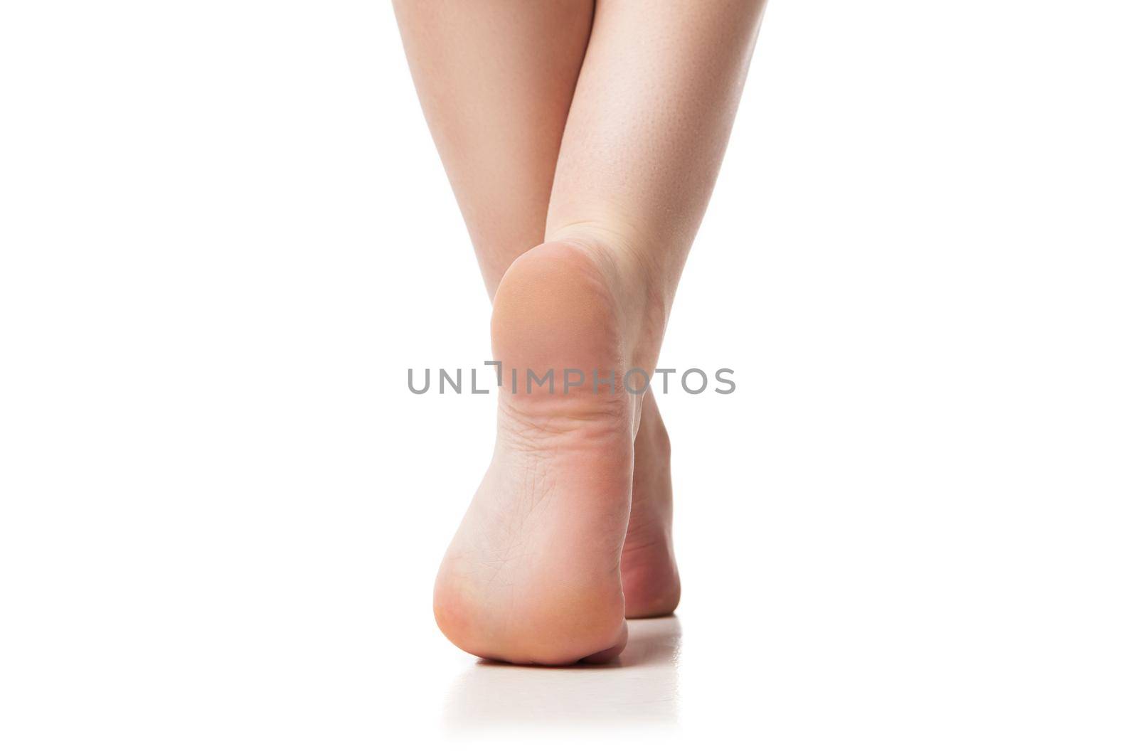 Woman foot on white background, isolated, close-up. Back view