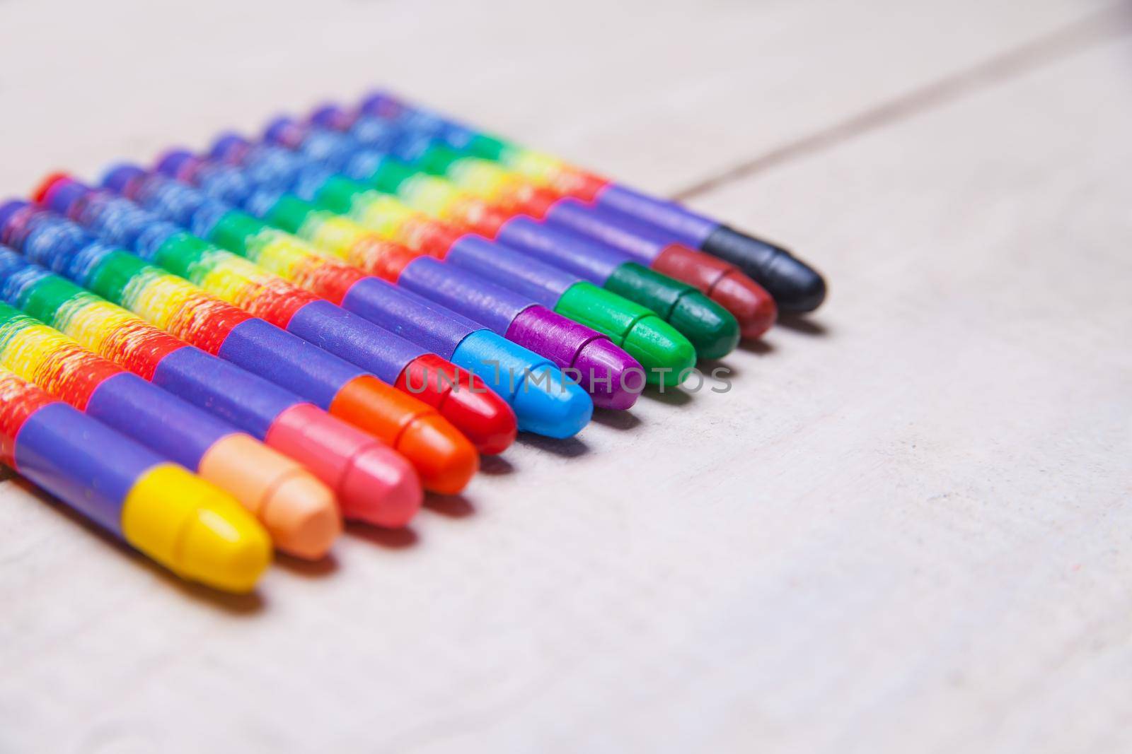 wax crayons on wood table by Julenochek