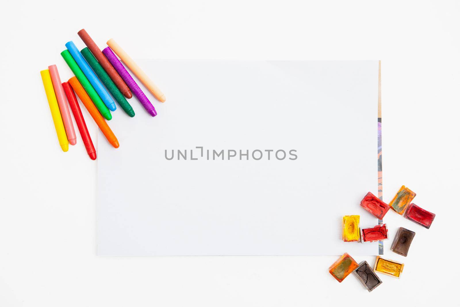 Colour pencils and watercolor on paper blank isolated on white background close up