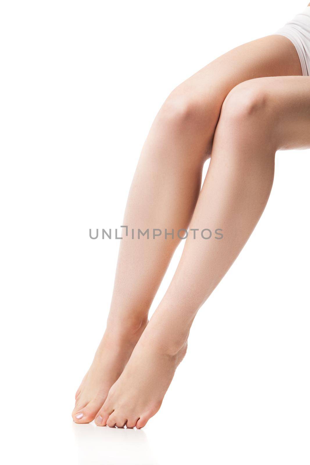 Close up of legs of young woman. Isolated on background