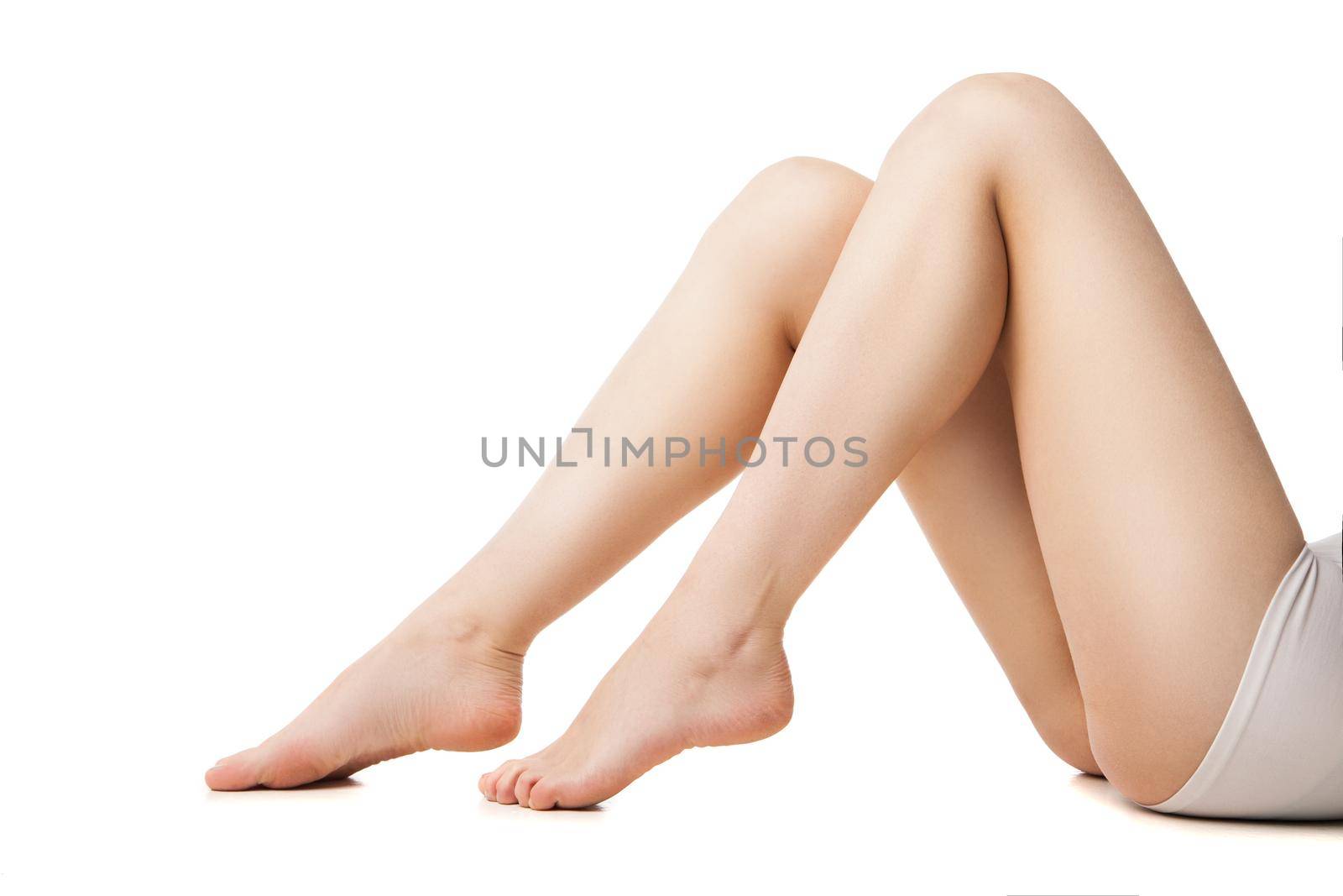 Close-up of young woman with beautiful legs lying by Julenochek