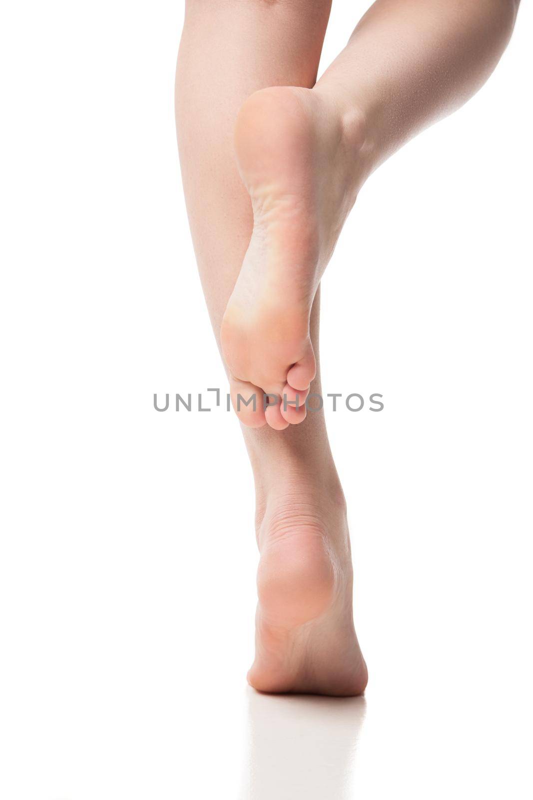 Back view of woman foot on white background, isolated, close-up by Julenochek