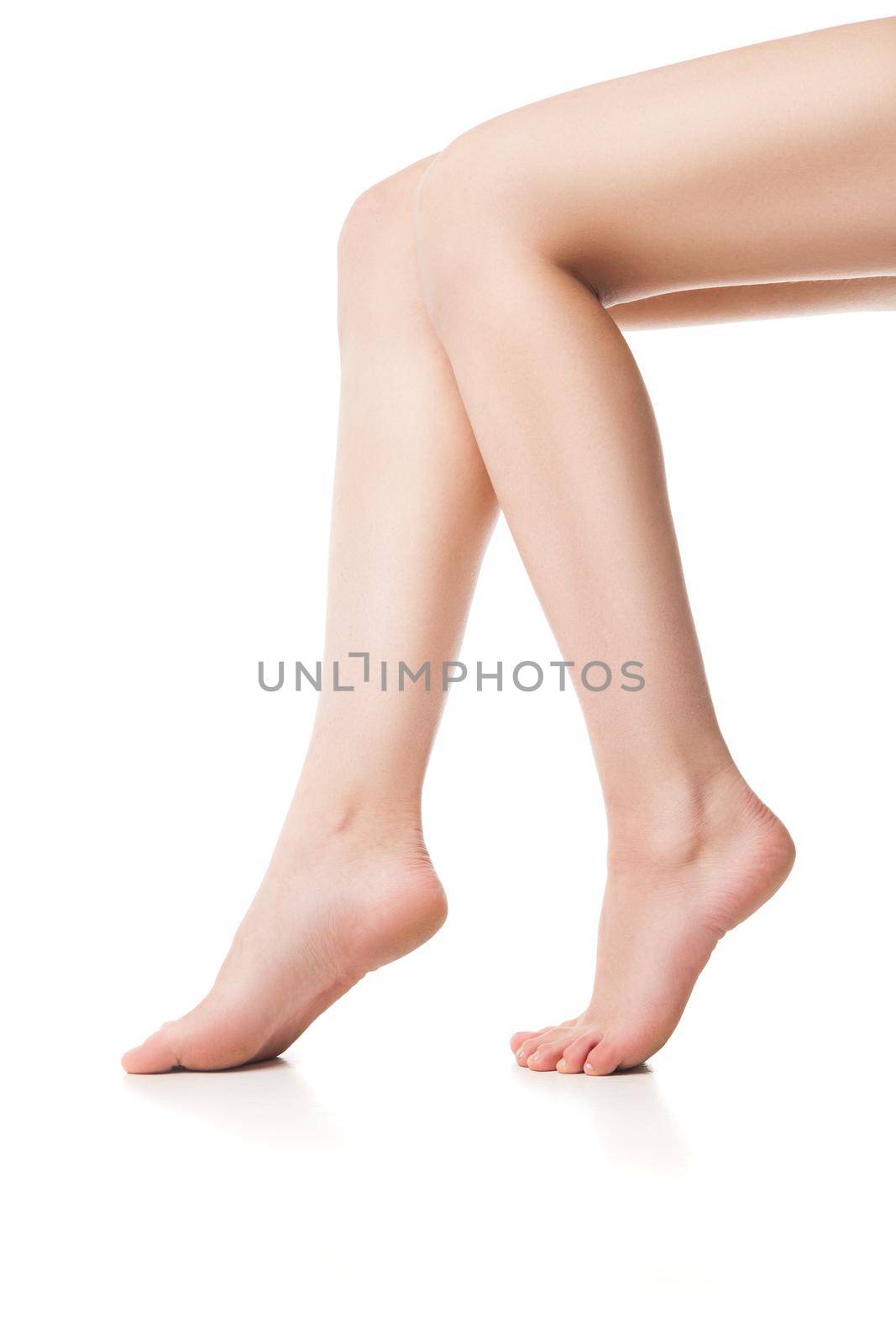 Close up of young woman's legs by Julenochek