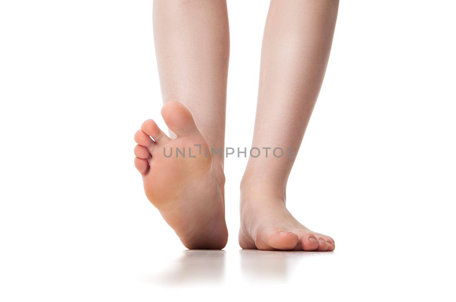 Close up of legs of young woman. Isolated on background