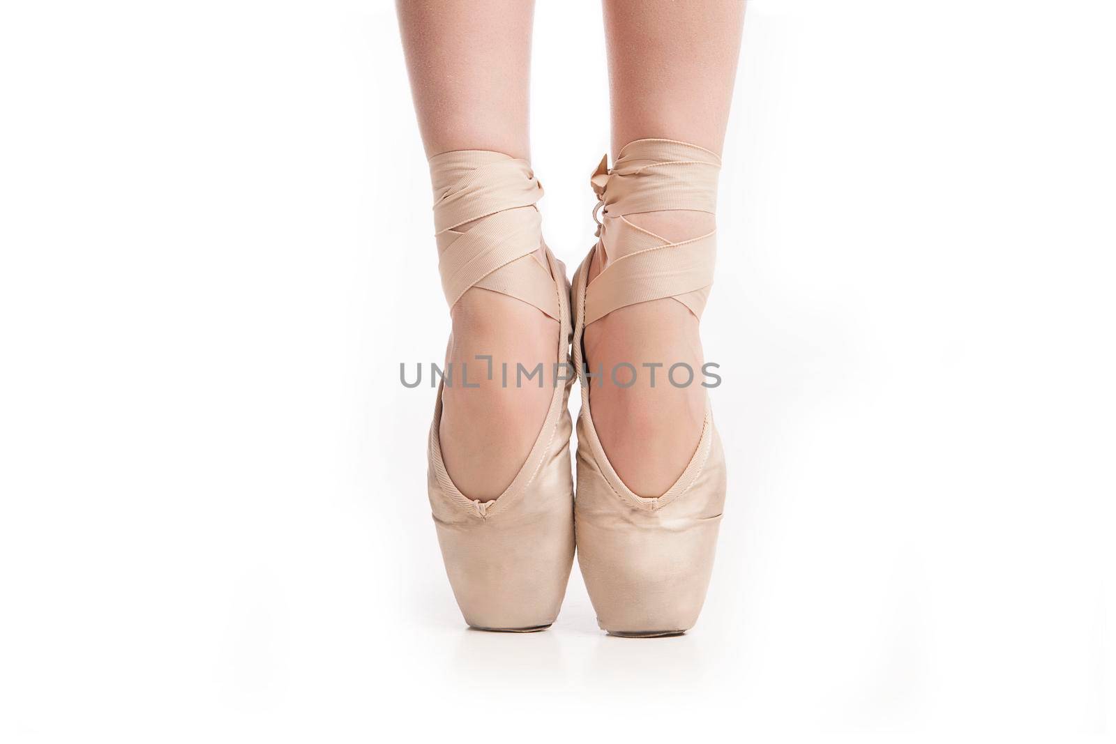 legs in pointe ballerina on white background by Julenochek