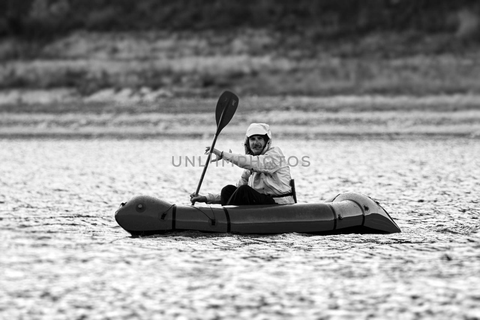 Swim in Packraft. Packraft, one-person light raft used for expedition or adventure racing, on a lake, inflatable boat Ride on a mountain lake by EvgeniyQW